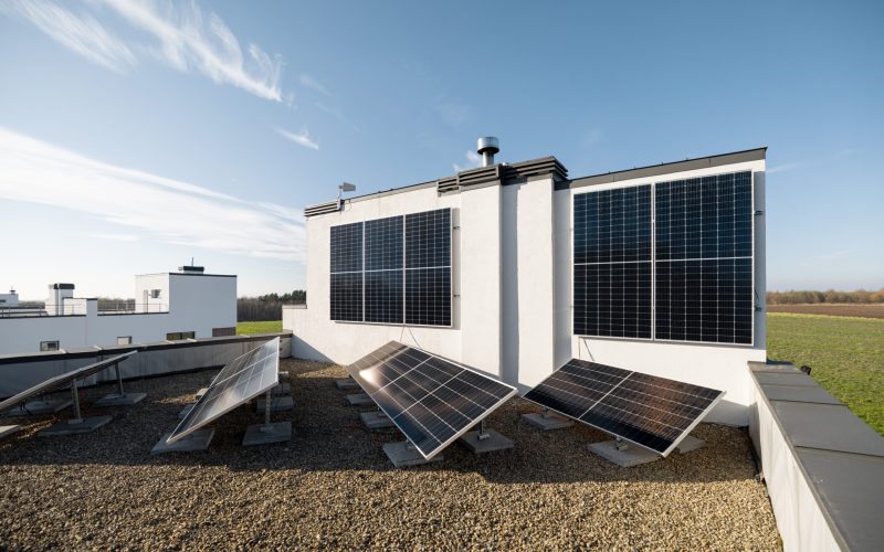 Household power plant installed on a flat roof and vertical wall. Concept of alternative energy and energy independence